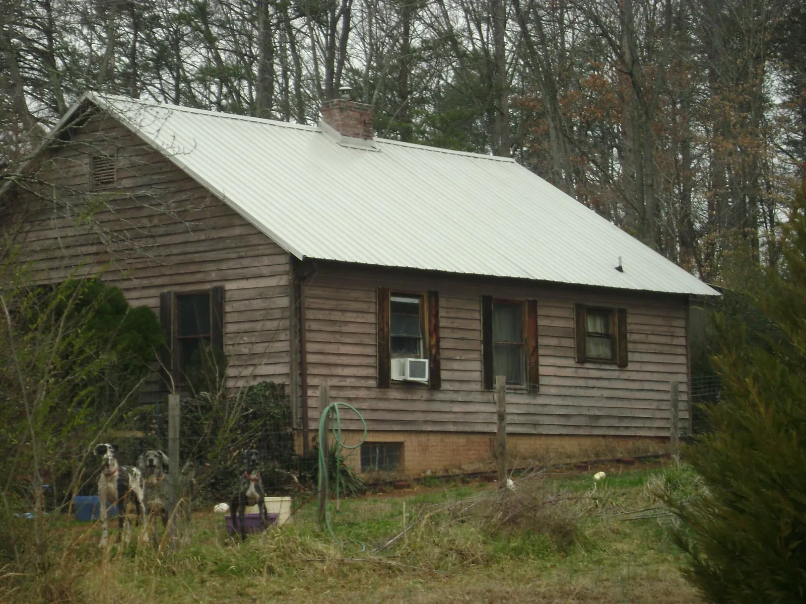 White metal roof on an old wood sided farmhouse, from a Metal Roof Installation job in Morgantown
